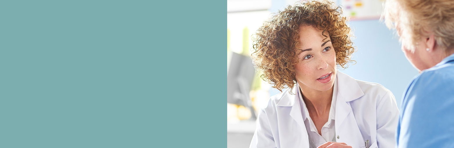 Clinician speaking to another person in a brightly colored room. 